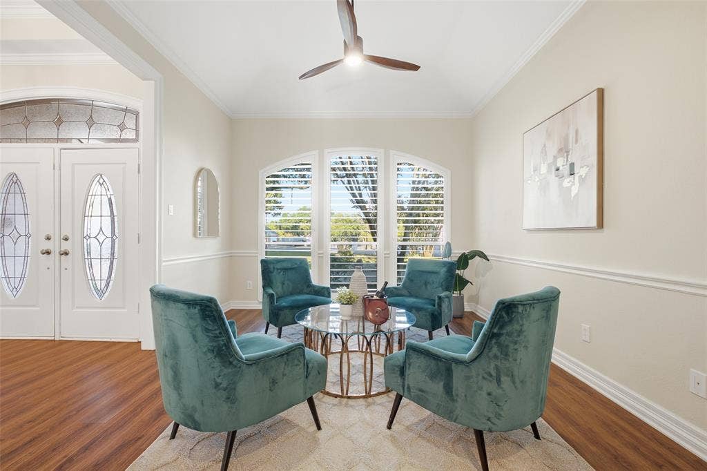 Bright front sitting room with arched plantation-shuttered windows: perfect for morning coffee or quiet conversation.