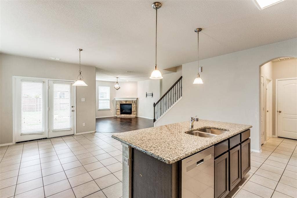 Kitchen island with stone-finish countertop and double basin sink