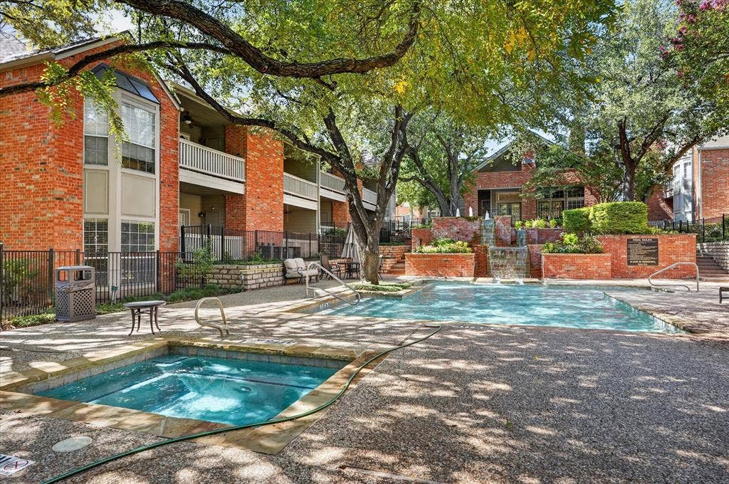 12660 Hillcrest Road, #5204, Dallas, TX 75230 Pool deck featuring a swimming pool, integrated spa, and a multi-tiered water feature