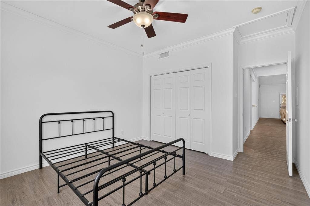 12660 Hillcrest Road, #5204, Dallas, TX 75230 Wood-finish flooring, ceiling fan with integrated lighting, bi-fold closet doors, and crown molding