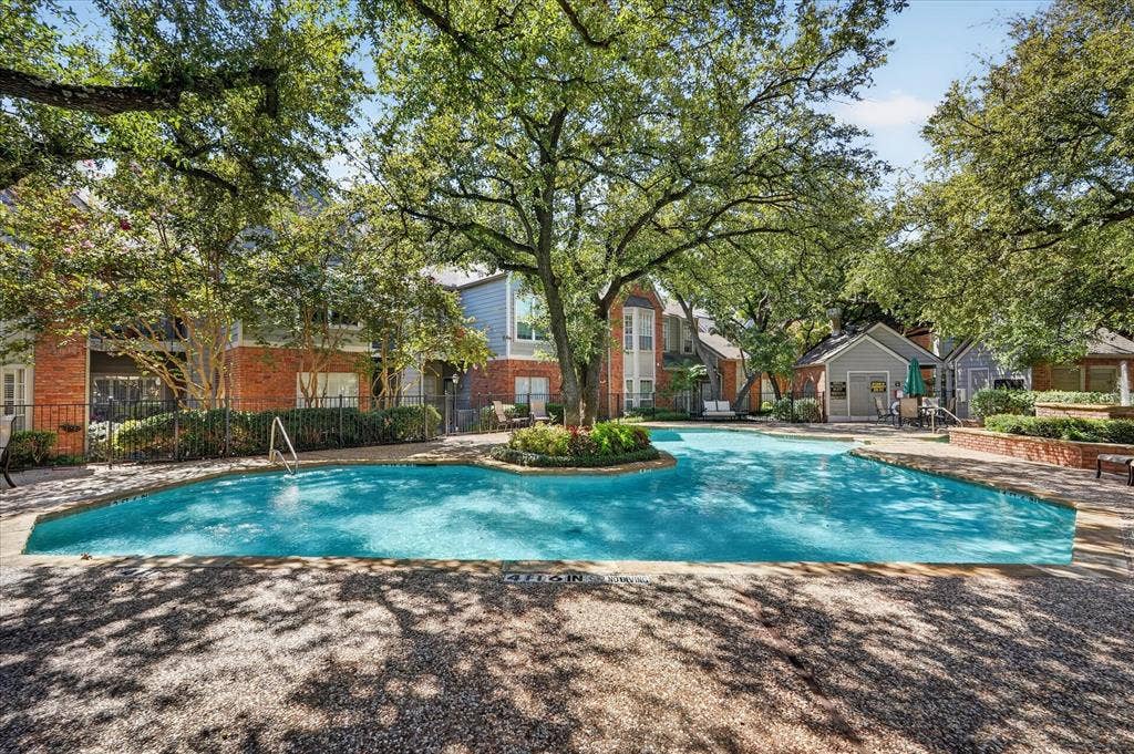 12660 Hillcrest Road, #5204, Dallas, TX 75230 Swimming pool with integrated landscaping and surrounding aggregate surface