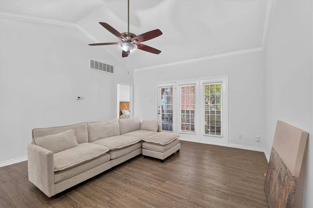 12660 Hillcrest Road, #5204, Dallas, TX 75230 Vaulted ceiling with a ceiling fan, crown molding, wood-finish flooring, and multiple window panels