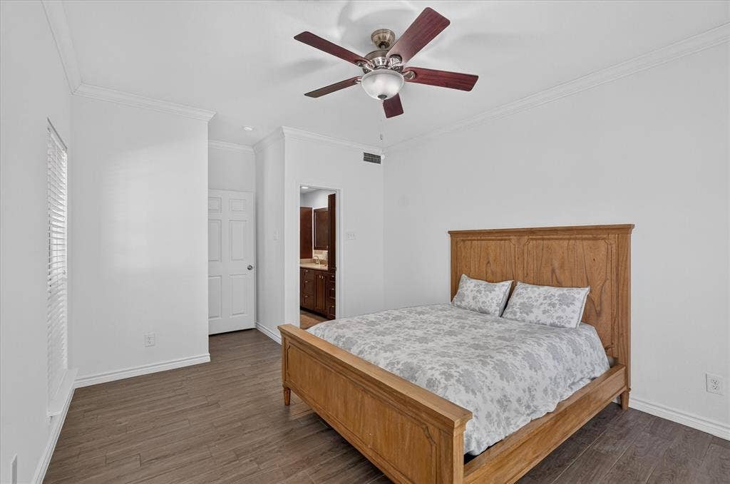 12660 Hillcrest Road, #5204, Dallas, TX 75230 Wood-finish flooring, crown molding, ceiling fan, white paneled door, and recessed lighting