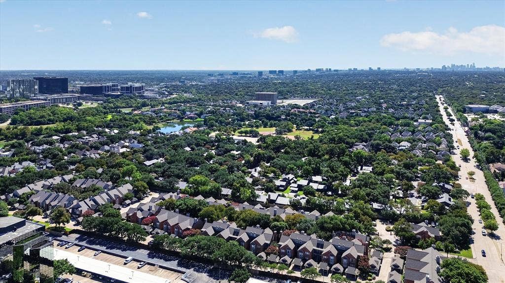 12660 Hillcrest Road, #5204, Dallas, TX 75230 Expansive urban landscape featuring mature tree canopy, residential developments, a public roadway, a body of water, and commercial buildings
