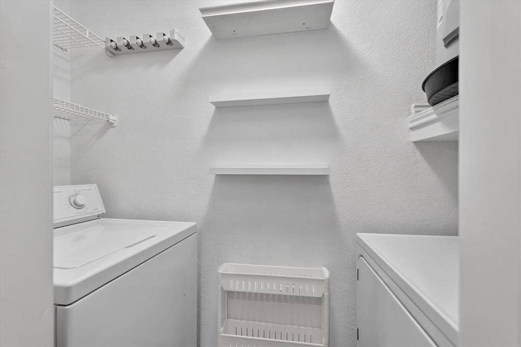 12660 Hillcrest Road, #5204, Dallas, TX 75230 White wall-mounted wire shelving, white wall-mounted floating shelves, and a white wall-mounted organizing rack