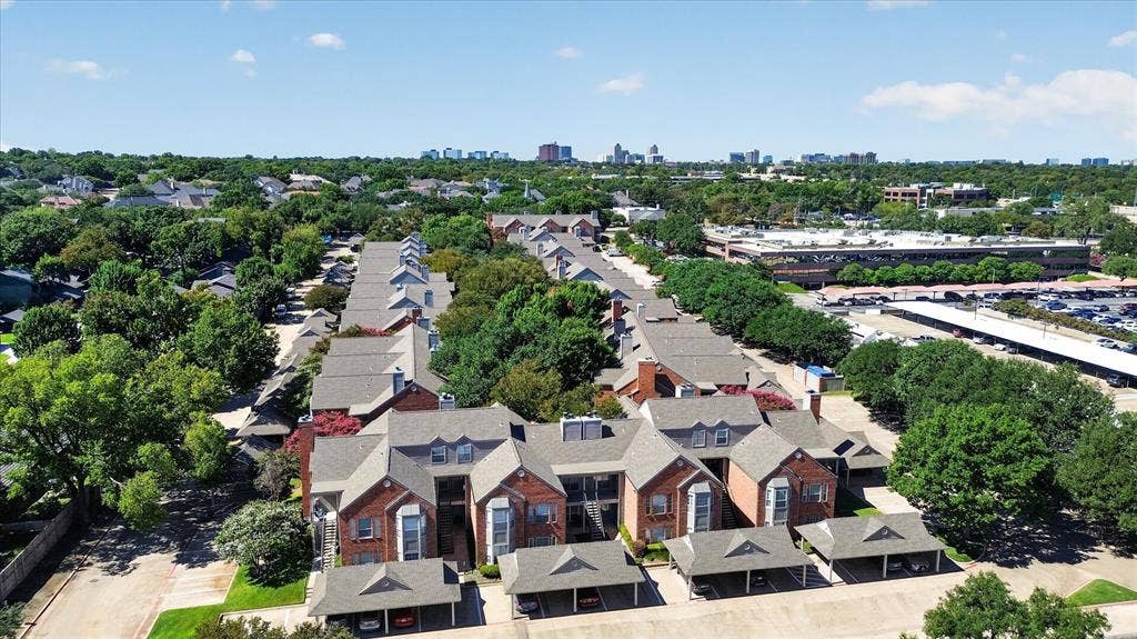 12660 Hillcrest Road, #5204, Dallas, TX 75230 Brick exterior construction with dormer windows, covered parking, and mature landscaping