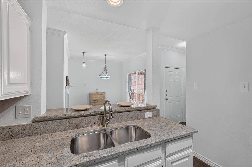 12660 Hillcrest Road, #5204, Dallas, TX 75230 Kitchen featuring granite countertops, a stainless steel double-basin sink, white cabinetry, and recessed lighting