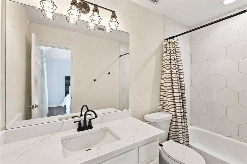 Vanity with integrated sink, quartz countertop, and matte black faucet