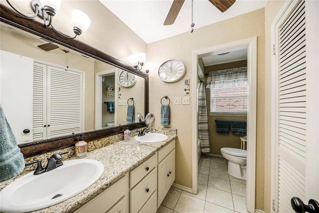 Dual sinks int he downstairs bath with granite counter tops and a ceiling fan as well! Tiled floors and tiled bath-shower!Medicine and linen cabinet!