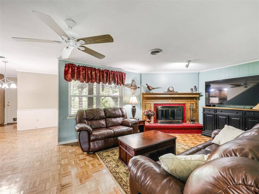 Views of the family room with raised hearth fireplace with gas logs and spotlight for the mantle and easy access to kitchen!