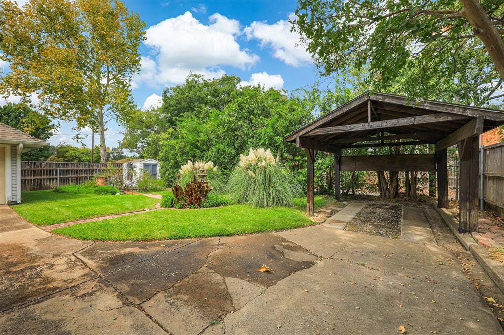 This property has sprinkler system for the lush landscaping and a view of the covered carport for additional covered parking!