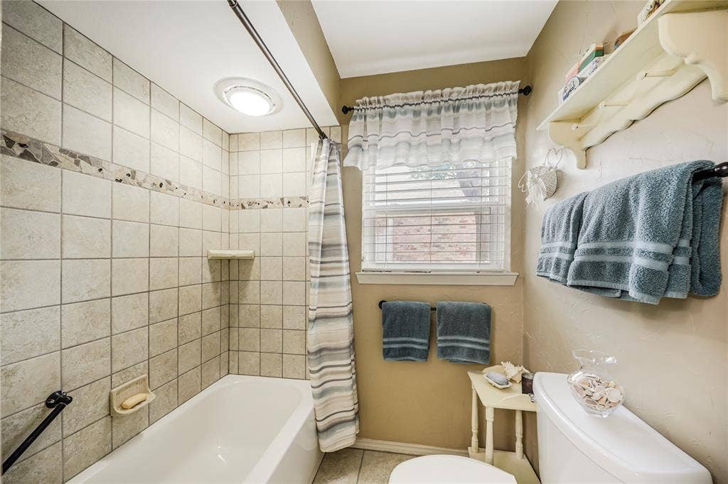 Views of the tiled shower -tub which has a nice safety rail as well!