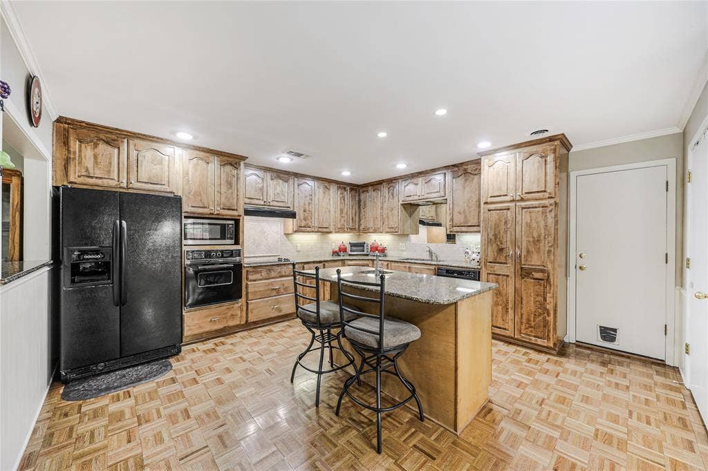 Spacious island renovated kitchen with 42 inch under cabinet lighted cabinets and custom pull outs and built in pantry.  Also extra vegetable sink built-in the island with granite countertops and opens to breakfast area and outdoor patio!