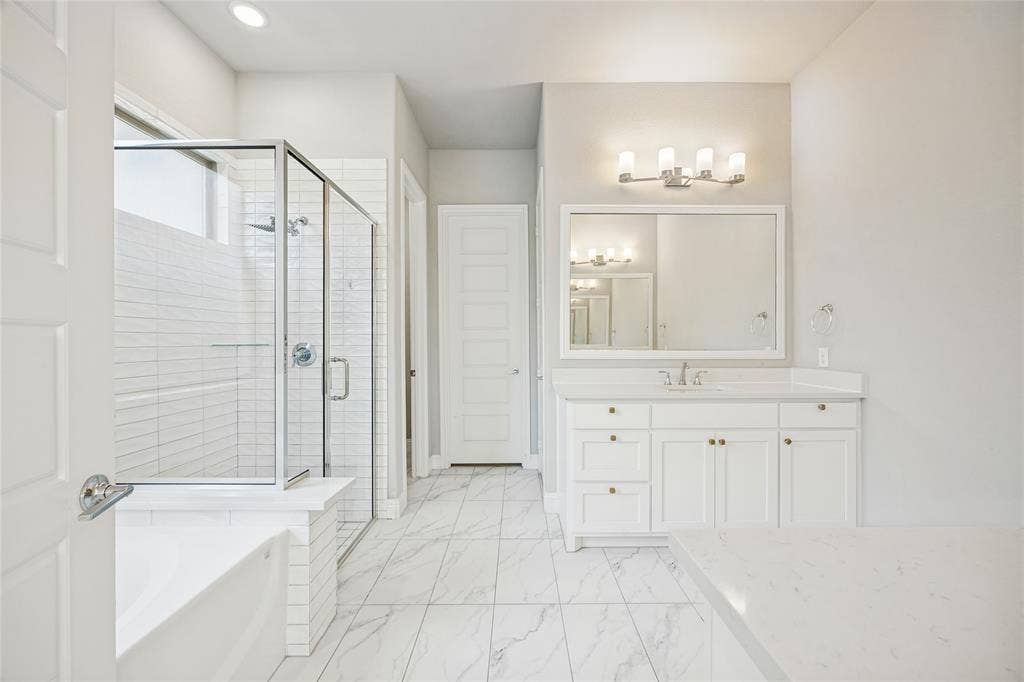 White vanity with an integrated sink and brushed nickel faucet