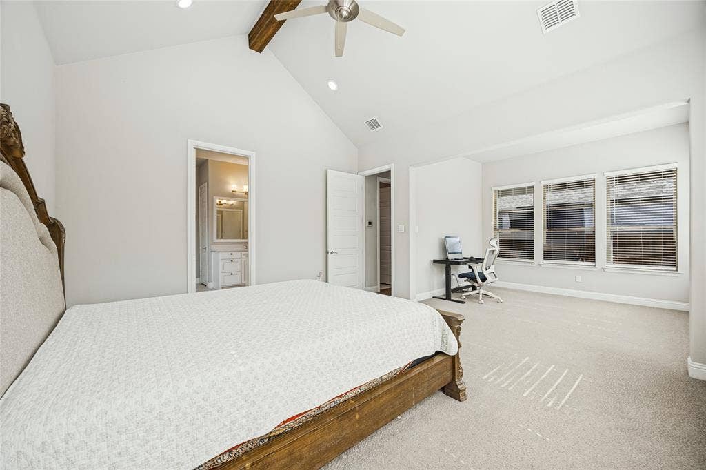 Vaulted ceiling with an exposed wood beam, recessed lighting, ceiling fan, and carpeted flooring