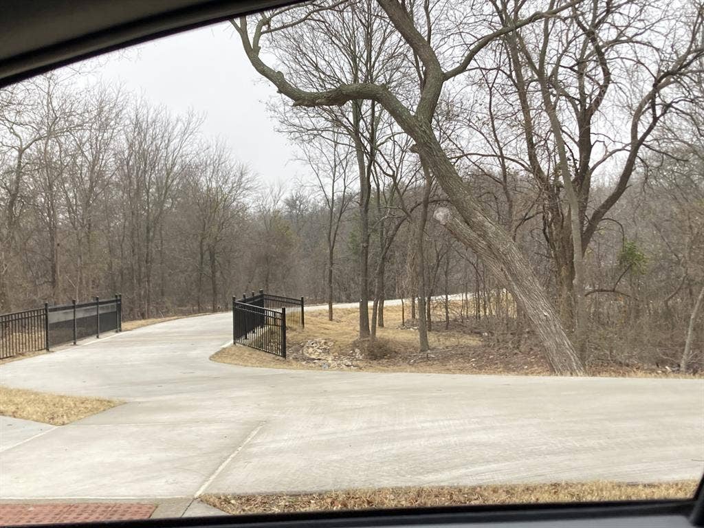 Concrete drive with black metal railing