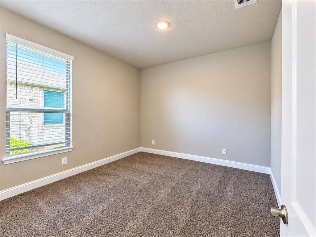 Carpeted room featuring a single window with blinds, recessed lighting, and neutral wall tones