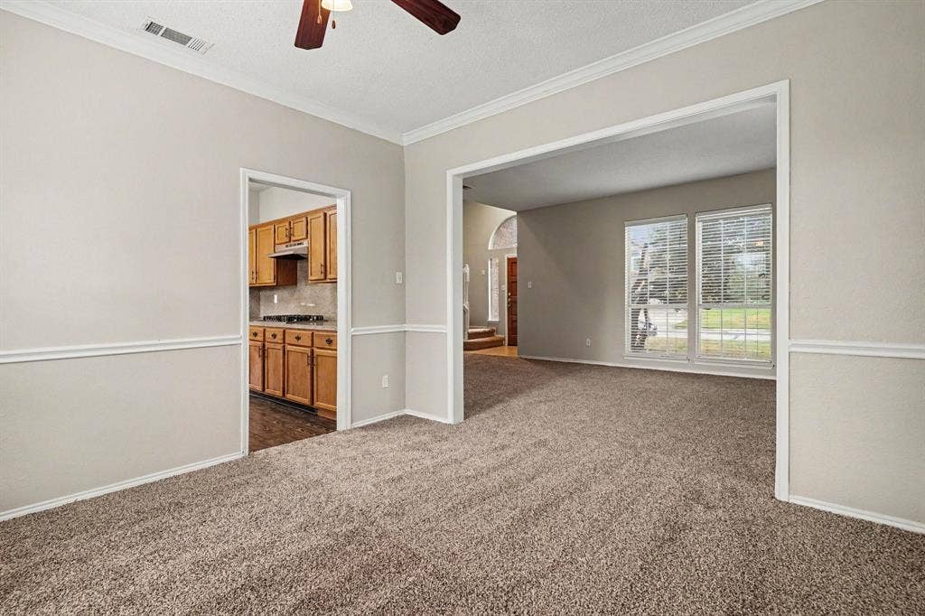 View from the formal dining room into the formal living and kitchen to the left side.