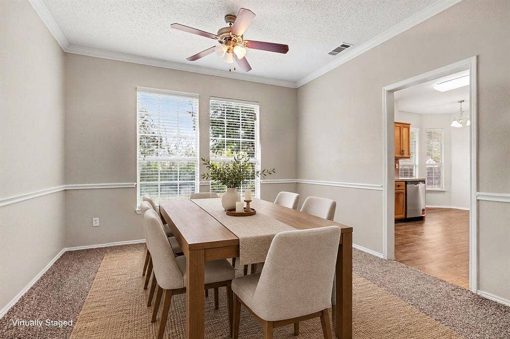 View into the virtually staged formal dining room. Opened to the living room