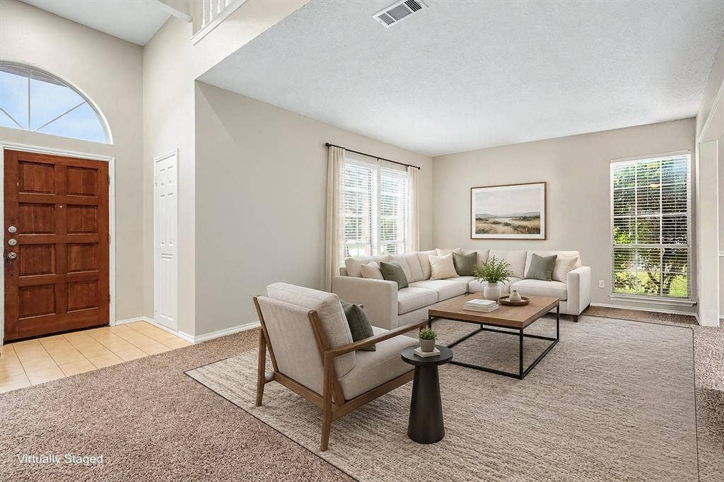 View of the virtually staged separate formal living room by the front entrance