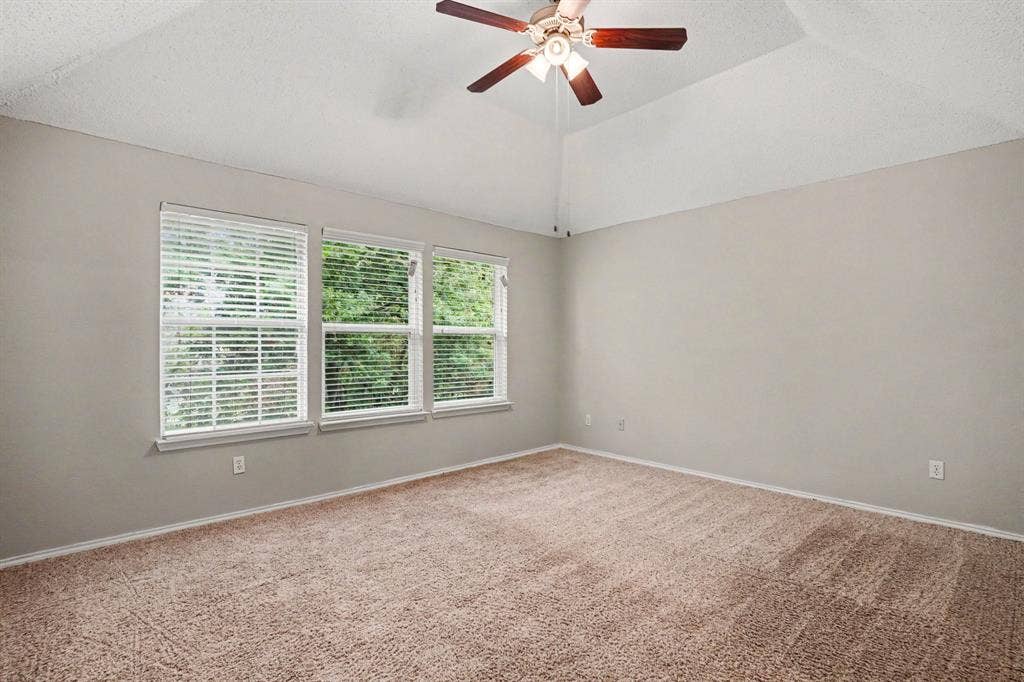 2nd floor: Primary bedroom with vaulted ceiling, large windows offering plenty of natural light.
