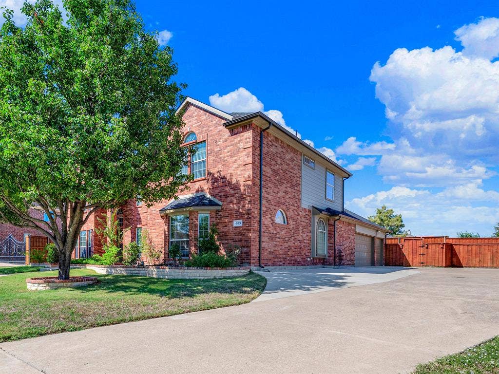 The expansive driveway provides generous parking space for multiple cars, a boat, or extra recreational gear alongside the garage. Pack up for a weekend on the lake or welcome friends for dinner with plenty of room for everyone to park.