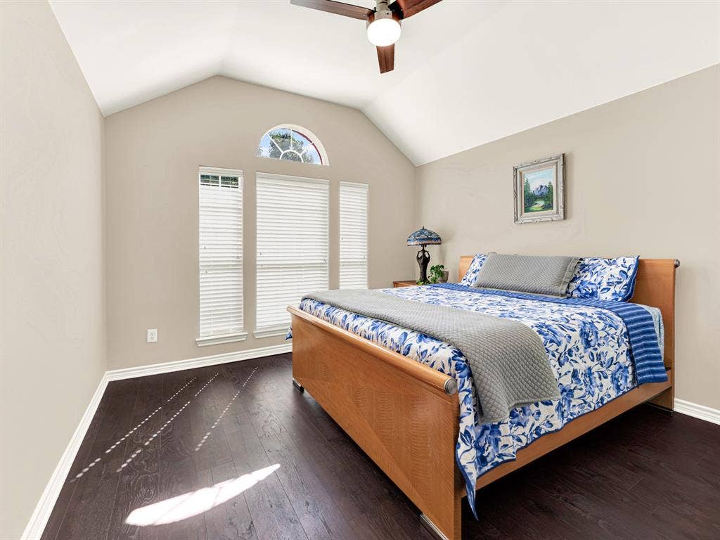 A broad central window flanked by slender panes creates a balanced focal point, scattering patterned sunlight across the dark flooring. Let the gentle daylight accompany a few minutes of journaling before the house gets busy.