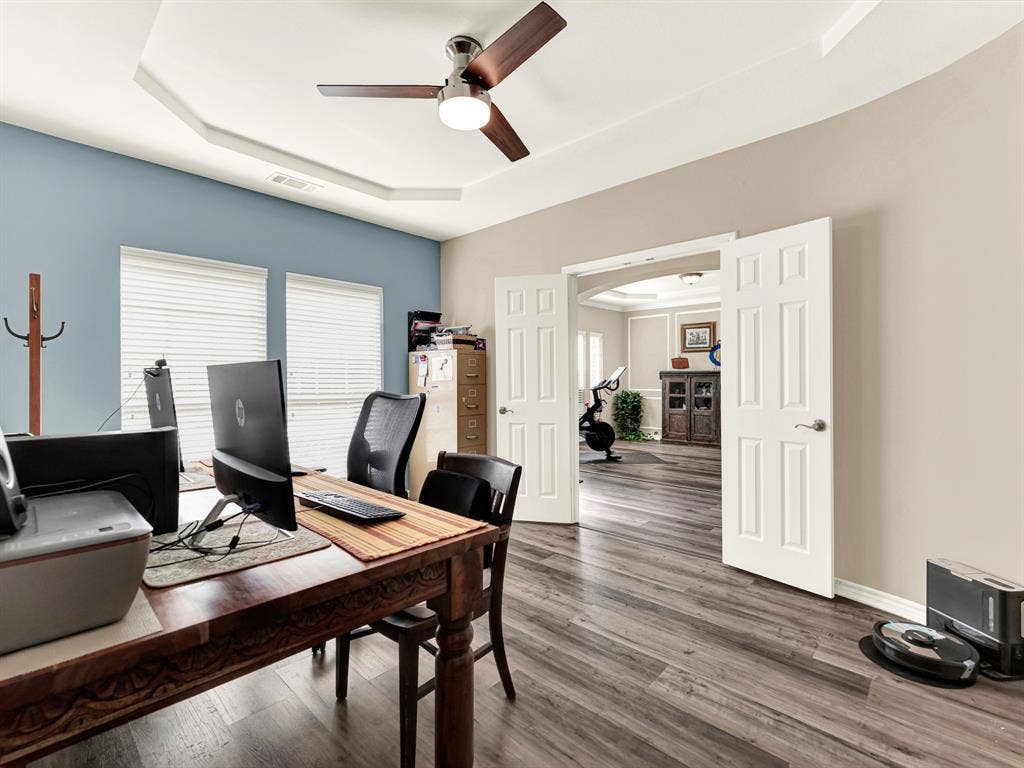 Double doors create a generous opening into the adjoining space, allowing the office to feel connected or comfortably enclosed. Close them for a focused afternoon call, then open them when your workday is done.
