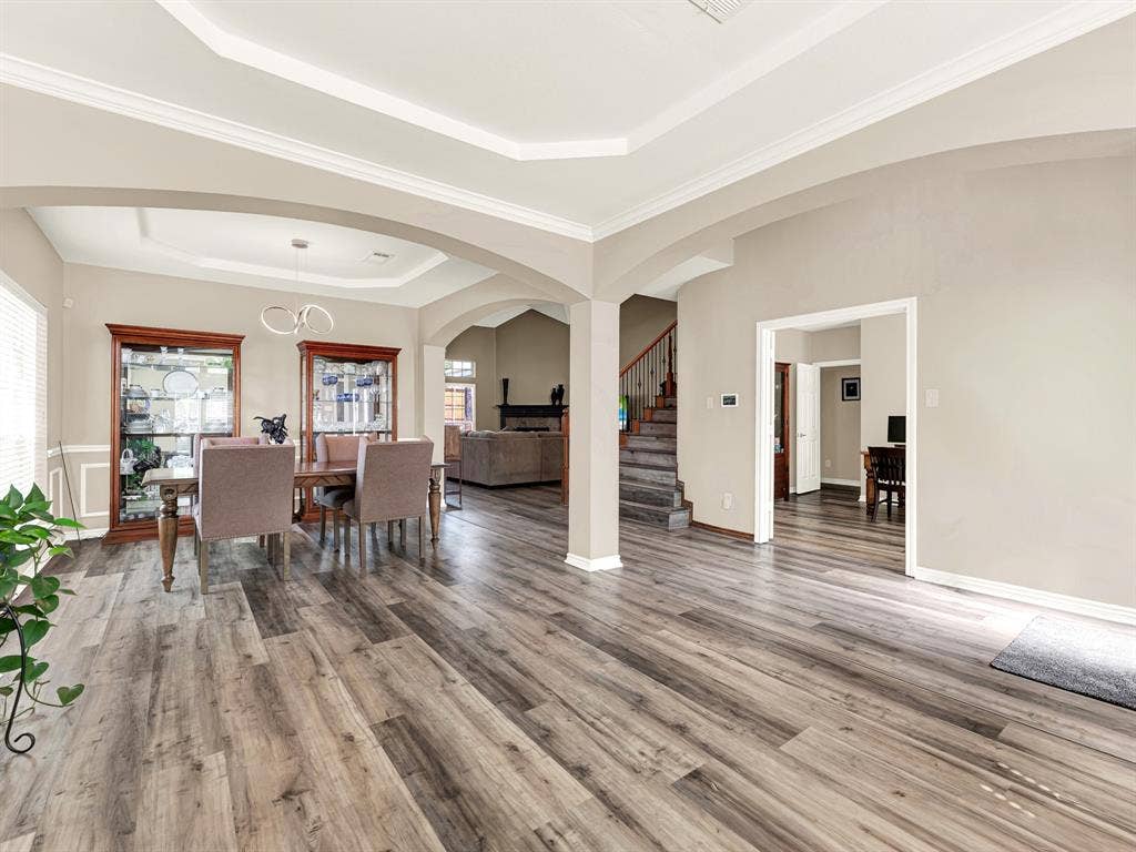 Substantial columns define the front living and dining spaces without interrupting the daylight or the generous sense of openness. Welcome arriving guests here, with room to mingle before sitting down to a meal.