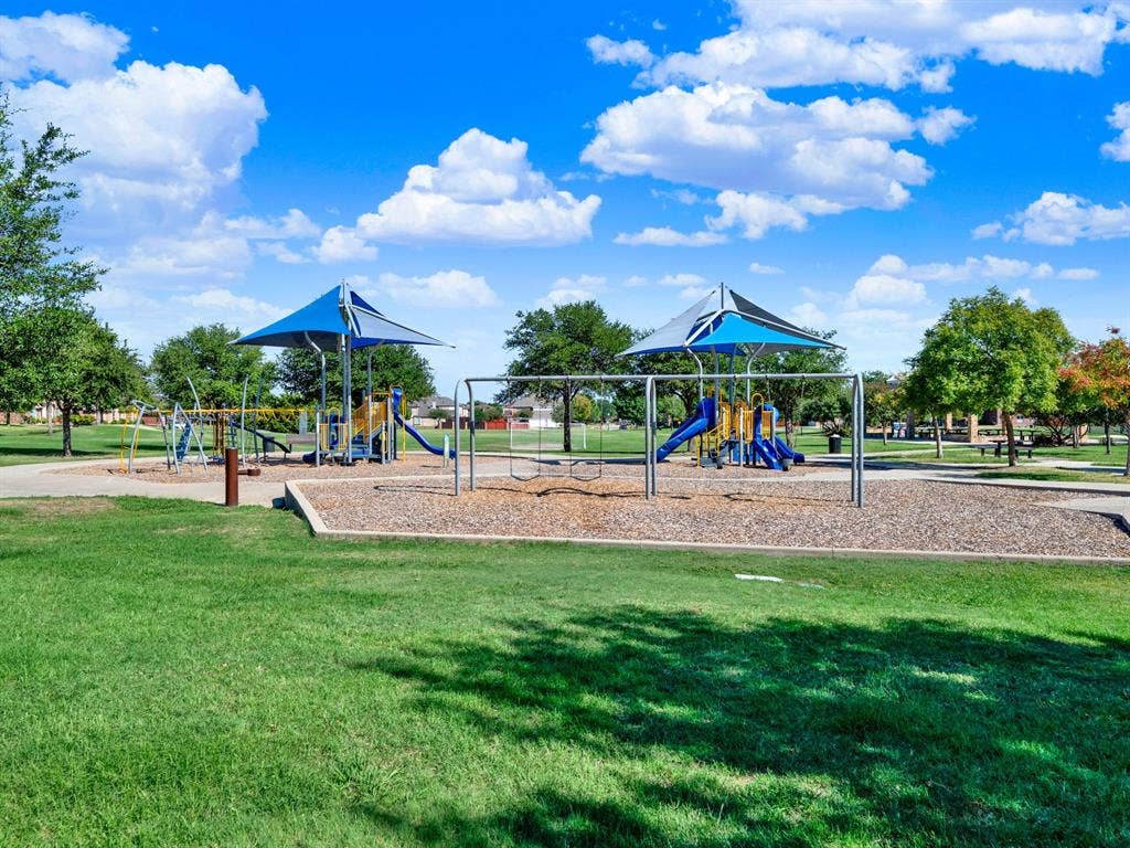 The community playground brings swings, slides, and climbing areas together in a park setting with plenty of green space. Turn an ordinary afternoon into a playdate while connecting with other families in the neighborhood.