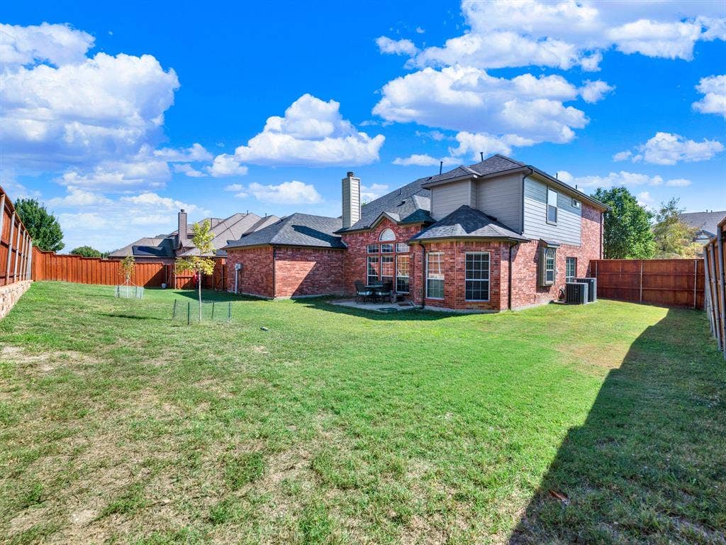 The huge backyard offers an expansive stretch of lawn with plenty of room to create your ideal outdoor living space. Picture lively cookouts, games on the grass, and evenings spent outside with the people you love.
