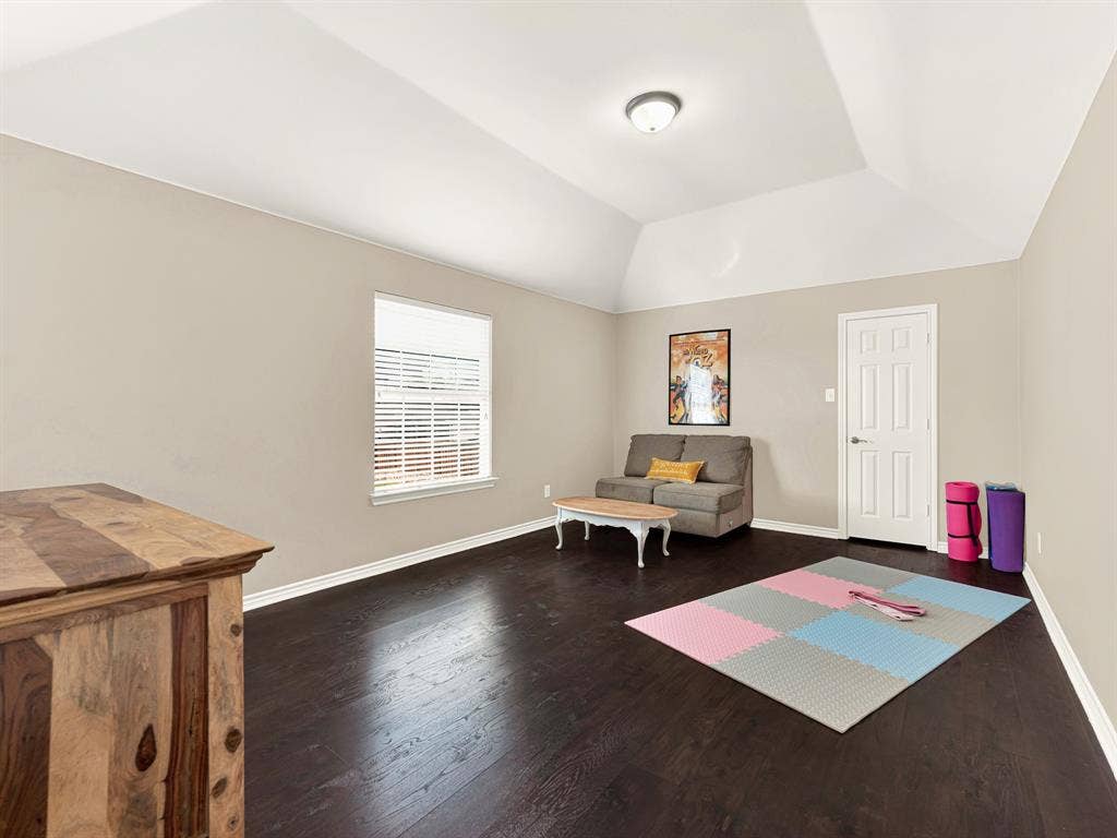 A faceted ceiling adds unexpected dimension to this flexible bedroom, with a side window illuminating its generous open floor. Carve out time for a gentle yoga session or a creative project away from the busier gathering spaces.