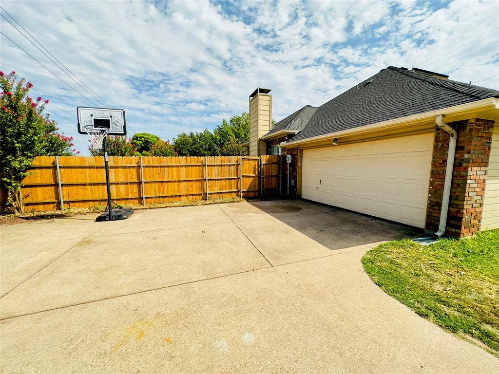 Concrete driveway leading to a two-car garage with a single door