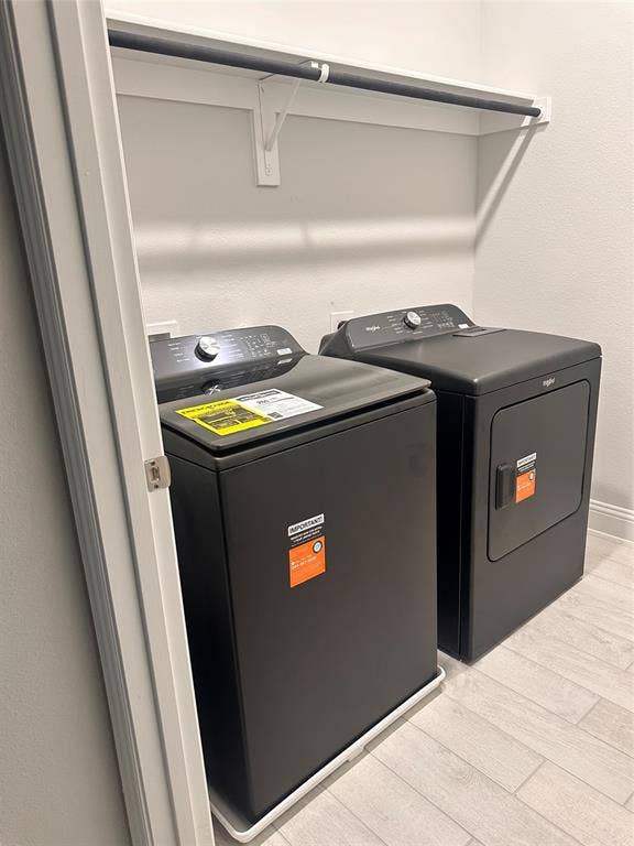 Washer and dryer units with a wall-mounted shelf and hanging rod