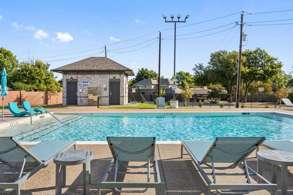 Outdoor swimming pool with integrated steps, surrounded by a concrete deck