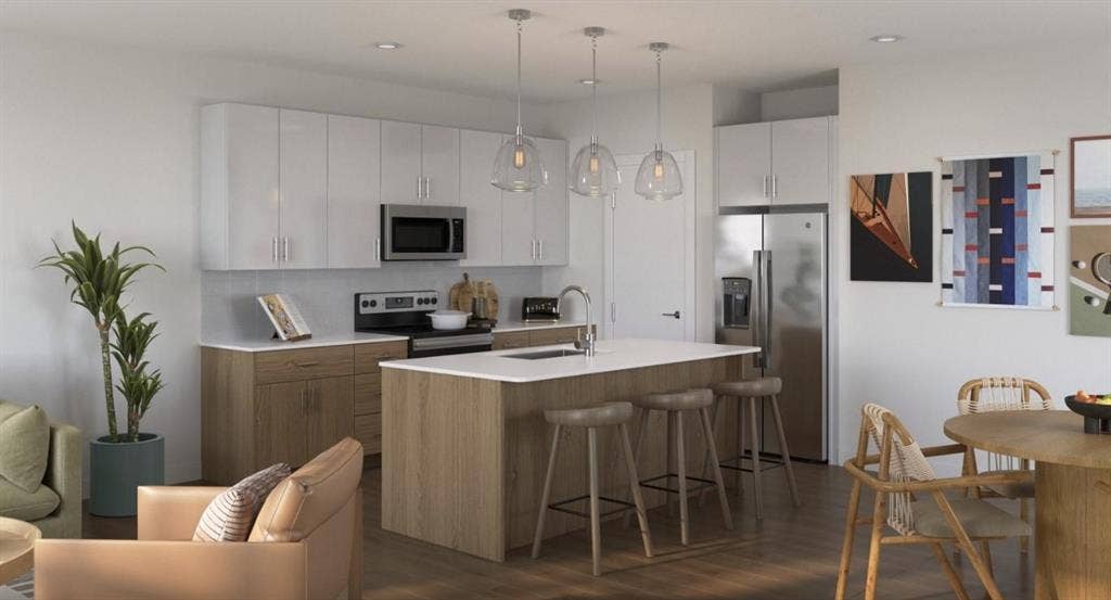 Kitchen featuring stainless steel appliances, a kitchen breakfast bar, hanging light fixtures, dark wood-style flooring, and recessed lighting