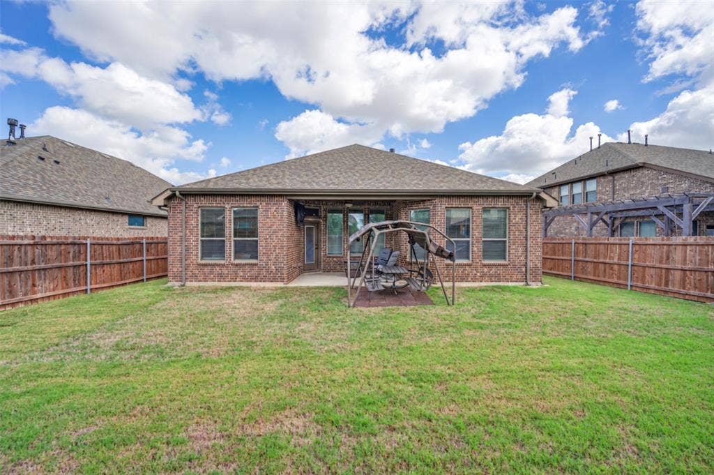 Full brick exterior, rear concrete patio, and fenced backyard