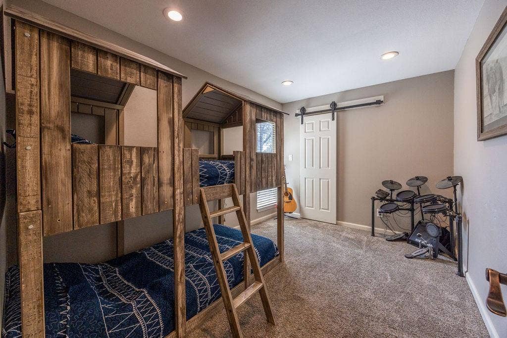 384 Fort Graham Road, Waco, TX 76705 Custom built-in bunk beds with wood paneling, recessed ceiling lighting, textured carpeting, and a white barn door