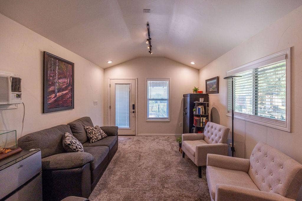 384 Fort Graham Road, Waco, TX 76705 Vaulted ceiling, track lighting, neutral wall finishes, window with blinds, and paneled door