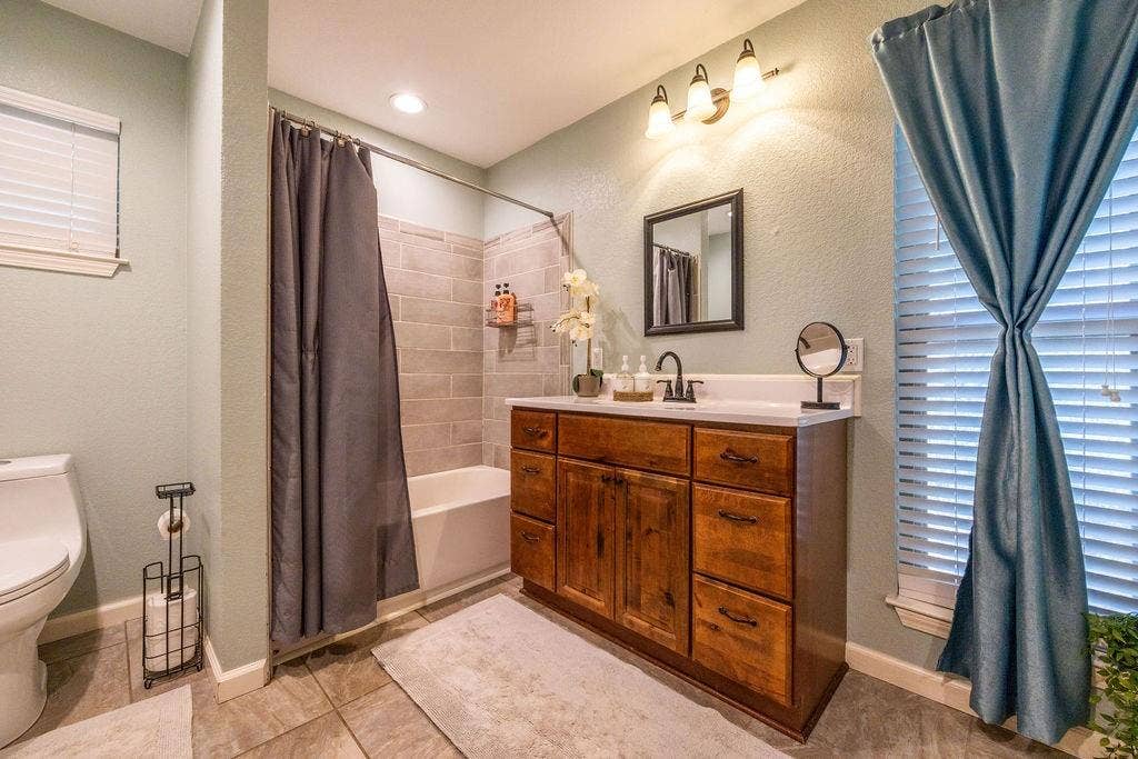 384 Fort Graham Road, Waco, TX 76705 Wood-finish vanity with a white countertop and rectangular sink