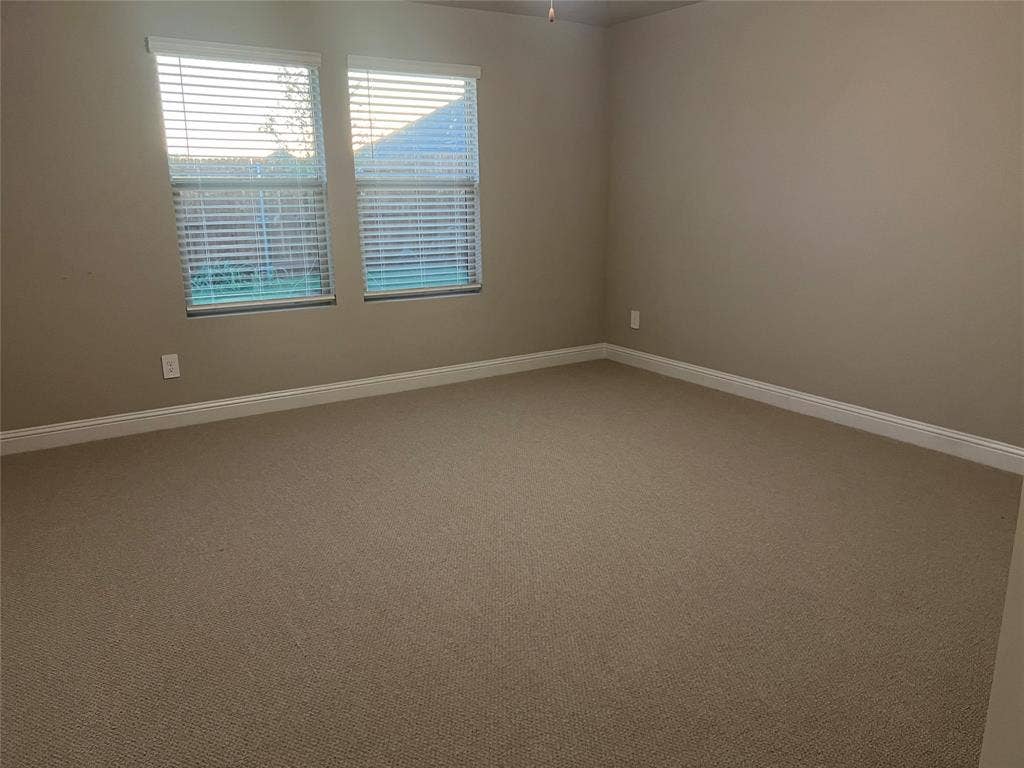 Warm neutral-toned walls complement the carpeted flooring