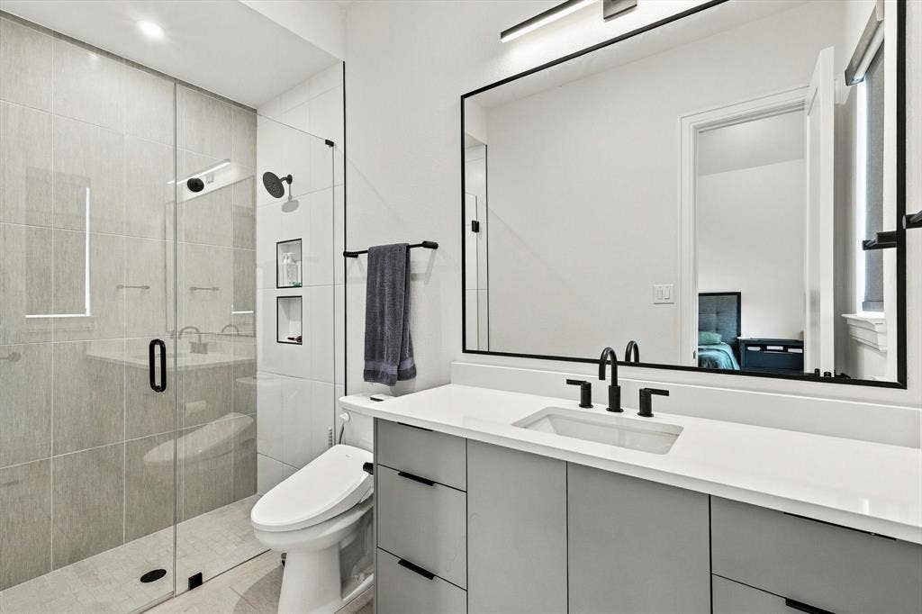 4301 Corabelle Lane, Prosper, TX 75078 Glass-enclosed shower with tiled walls and built-in niches