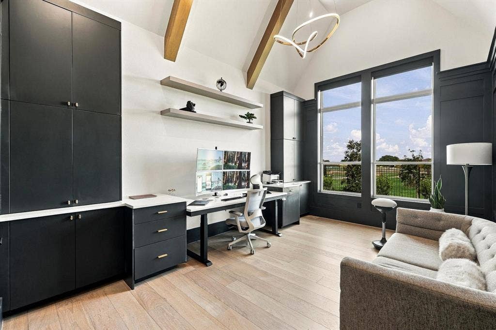 4301 Corabelle Lane, Prosper, TX 75078 Vaulted ceiling with exposed wood beams, extensive built-in cabinetry with white countertops, large windows, wood-finish flooring, and a contemporary chandelier