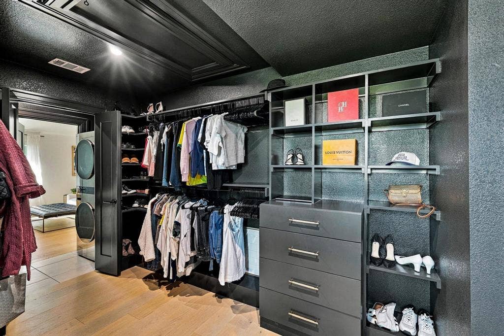 4301 Corabelle Lane, Prosper, TX 75078 Custom closet system featuring built-in shelving, hanging rods, and integrated drawers