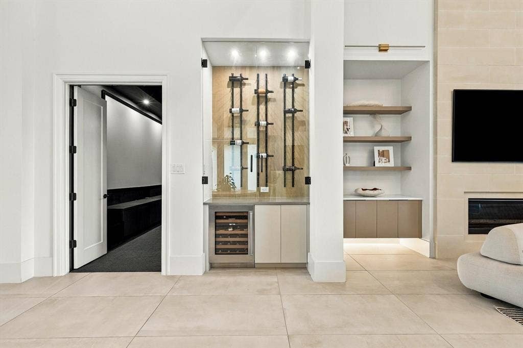 4301 Corabelle Lane, Prosper, TX 75078 Built-in wine storage with glass enclosure, integrated wine refrigerator, and recessed lighting