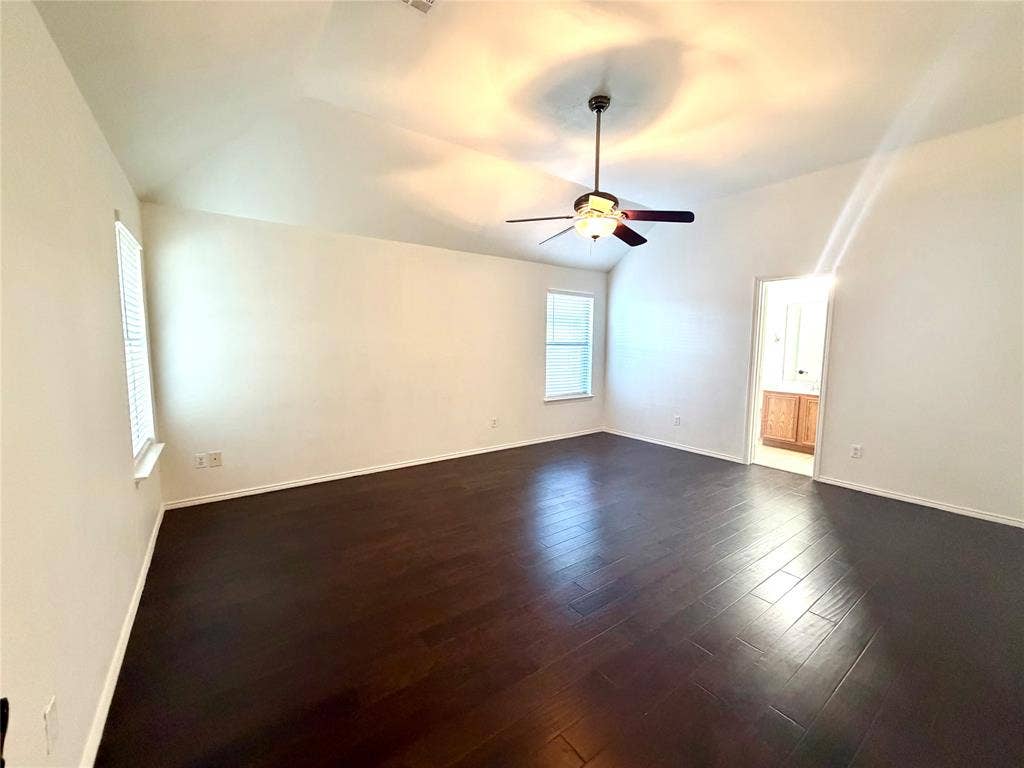 9016 Warren Drive, McKinney, TX 75071 Vaulted ceilings, wood-finish flooring, dual windows, and an integrated ceiling fan with light fixture