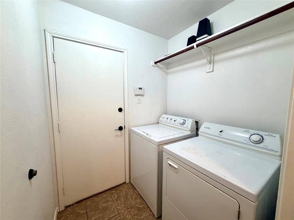9016 Warren Drive, McKinney, TX 75071 Utility room featuring tiled flooring, a mounted upper storage shelf with hanging rod, and a solid-core entry door