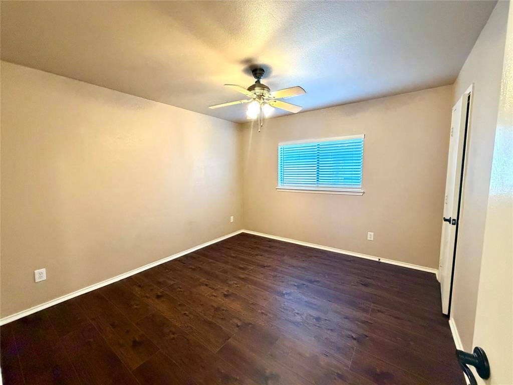 9016 Warren Drive, McKinney, TX 75071 Room featuring wood-finish flooring, a ceiling fan with integrated lighting, and a single-pane window with horizontal blinds