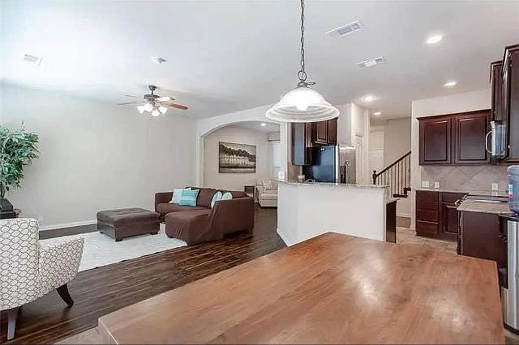 Living room featuring ceiling fan and hardwood / wood-style flooring