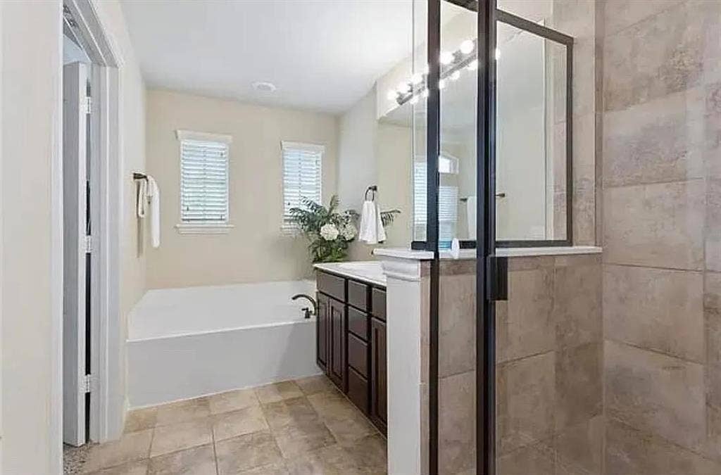 Bathroom featuring vanity and plus walk in shower